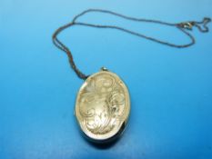 A 9ct gold locket with chased foliate decoration