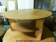 An Art Deco style oak coffee table with undershelf raised on three legs (diameter 91cm height 46cm)