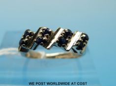 An 18ct white gold ring set with sapphires (size F)