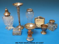 A quantity of hallmarked silver items to include trumpet vase, egg cup, perpetual calendar,