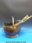 A copper helmet style coal bucket together with fire irons etc