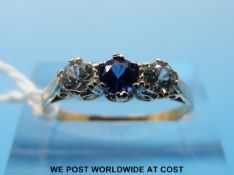 A 9ct gold ring set with a sapphire flanked by two cubic zirconia (size N)