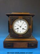 A French mantel clock with carved decoration to case, the anonymous movement striking on a bell.
