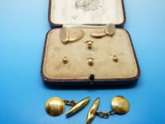 A pair of 9ct gold cufflinks with engine turned design and matching 9ct gold studs in original box