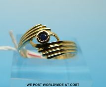A 9ct gold ring set with a sapphire in a twist setting