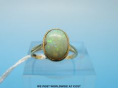 A gold ring set with an oval opal (size K)