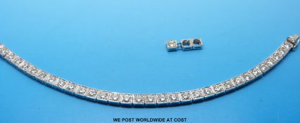 An 18ct white gold bracelet set with 32 round brilliant cut diamonds each approximately 0.
