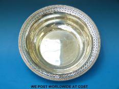 A white metal bowl with pierced edge, marked to underside sterling silver (diameter 25.