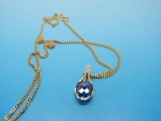 A 14ct gold pendant set with a London blue topaz and diamonds on an 18ct gold chain