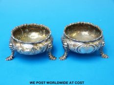 A pair of George II hallmarked silver hoof footed open salts,