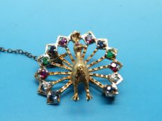 A yellow metal brooch set with diamonds, rubies,