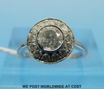 A platinum and diamond ring, the central stone of approximately 0.