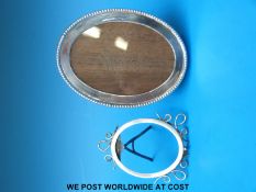 An oval hallmarked silver photograph frame with fold-out stand to back (15cm maximum diameter)