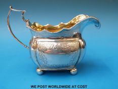 An Irish Georgian hallmarked silver cream jug with bright cut decoration Dublin 1814,
