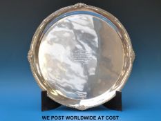 A large hallmarked silver salver raised on three lion pad feet, B'ham 1936,