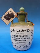 A stoneware decanter of Uisge Baugh Irish whiskey (26 2/3 fl oz) and two glass Art Deco style
