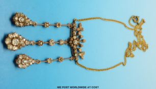 An early Victorian gold necklace set with old cut diamonds the three pear shaped drop sections
