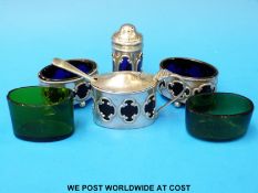 A four-piece hallmarked  silver cruet with blue glass liners and spare green liners (B'ham,