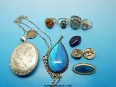 A large silver locket, silver pendant set with butterfly wing, silver and enamel brooch,