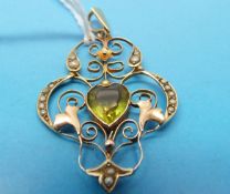 An Edwardian pendant marked 9ct set with seed pearls and a heart shaped peridot