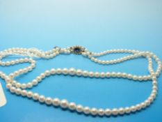 A two strand pearl necklace with cluster clasp
