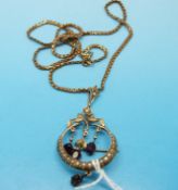 An Edwardian 9ct gold pendant / brooch set with amethysts and seed pearls on a 9ct gold chain