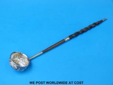A white metal whale bone-handled toddy ladle (35cm long)