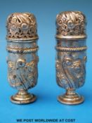 A hallmarked silver salt and pepper with embossed design (height 9.