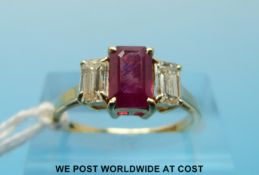 An 18ct gold ring set with an emerald cut ruby of approximately 0.