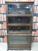 A Globe Wernicke four section oak bookcase with drawer below (H166, W87,