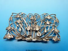 A hallmarked silver belt buckle with pierced floral decoration, probably violets, 9x5.5cm.