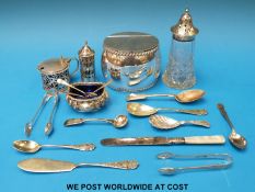 A hallmarked silver mustard, silver open salt and silver pepper all with blue glass liners,