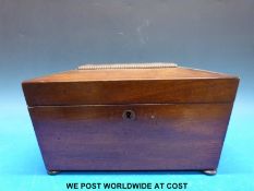A 19thc mahogany sarcophagus shaped tea caddy with bun feet