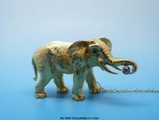 An 18ct gold Tiffany brooch in the form of an elephant with a diamond in its tusk and sapphire eyes,