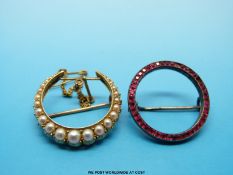 A gold brooch set with pearls in a crescent shape together with a circular brooch set with red