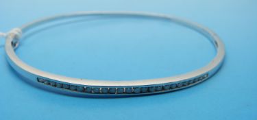 A 9ct white gold bangle set with diamonds