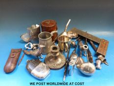 A set of five graduated plated beakers in a leather case, a hallmarked silver funnel,