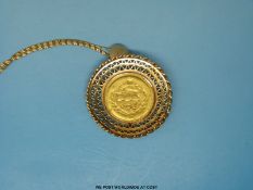 A yellow metal brooch set with a mounted gold 1/2 Pahlavi of Shah Muhammed Reza on a 18ct gold