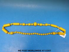 A retro 1930s bakelite necklace and a pair of cocktail stirrers with dice finials