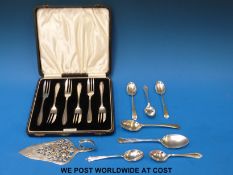 A cased set of six hallmarked silver cake forks together with seven various hallmarked silver