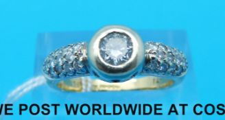 An 18ct gold ring set with a round brilliant cut diamond measuring 0.