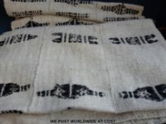 Three African batiks together with two cream ground Kuba dance skirts