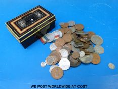 A collection of largely UK coinage in a vintage money box including a George III 1822 crown,