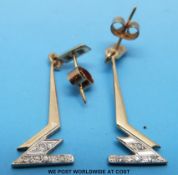 A pair of 9ct gold earrings set with diamonds in a platinum setting