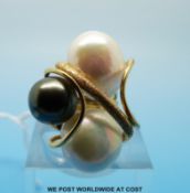 An 18ct gold ring set with two natural south sea pearls and a Tahitian pearl (with Birmingham