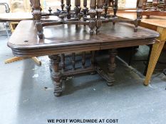 A continental extending dining table raised on turned supports (length 130cm x width 112cm x height
