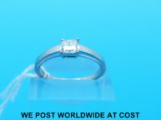 A platinum ring set with a princess cut diamond of approximately 0.
