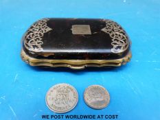 A tortoiseshell purse with silver plated surround and white metal inlay (width 9cm) with two coins