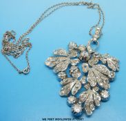 A platinum pendant set with old cut diamonds in a foliate design (largest stone approximately 0.