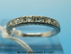 A platinum ring set with eight princess cut diamonds (size M)